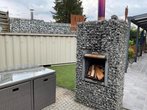 a stone oven with wood inside of it at Relax Trois Bornes - De Grenspost in Gemmenich