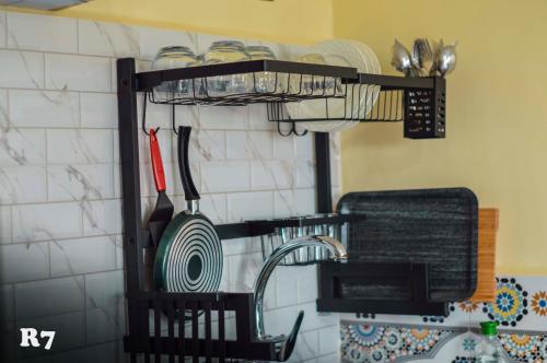 a kitchen rack with plates and utensils on a wall at Chalets ITO Atlas Timnay in Midelt