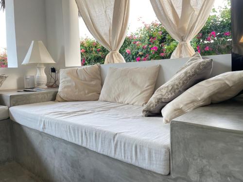 a white couch in a living room with a window at Charming Coastal Apartment in Watamu