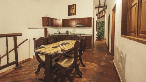 a kitchen with a wooden table and chairs in a room at Kasazha- Casa entera en Barichara 3 habitaciones. in Barichara