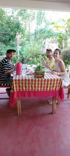 a group of people sitting around a table at Sigiriya Moonlight Home in Sigiriya