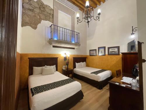 Postel nebo postele na pokoji v ubytování Hotel Historia