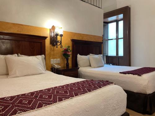 Postel nebo postele na pokoji v ubytování Hotel Historia