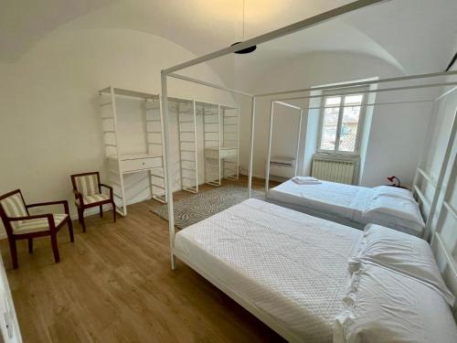 a bedroom with two beds and a desk and chair at Le Volte di via Portica - Deluxe Apartments Italia in Assisi