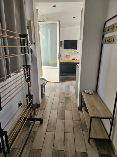 a kitchen with a table and a wooden floor at Jolie maison proche complexe sportif Wifi REMISE MC ARTHUR in Saint-André-les-Vergers
