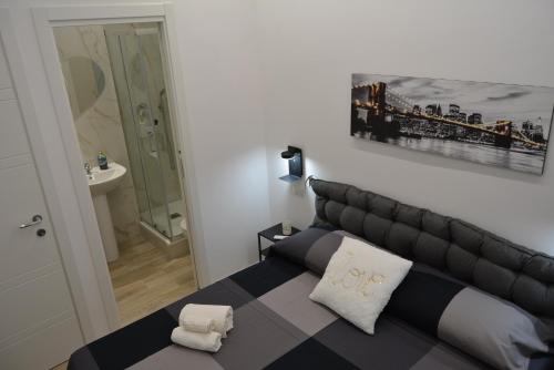 a bedroom with a black and white bed and a bathroom at Casa Amabile in Rome