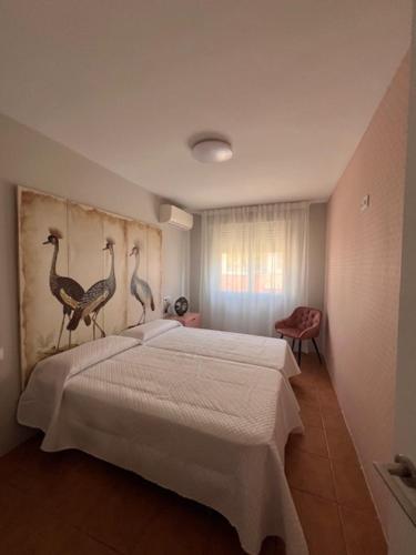 a bedroom with a bed with birds on the wall at ALMA de Bardenas in Arguedas