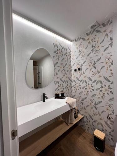 a bathroom with a white sink and a mirror at ALMA de Bardenas in Arguedas