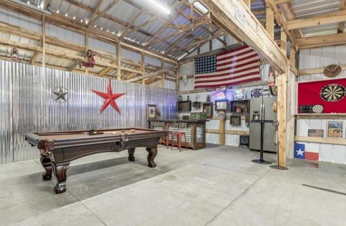 a room with a pool table and an american flag at The Log Palace Private Guest Suite in White House