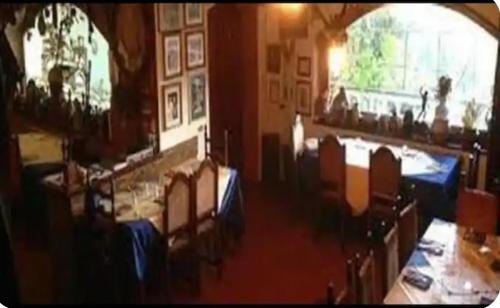 a dining room with two tables and chairs and a room with at La casa di Mario in Rocca di Papa