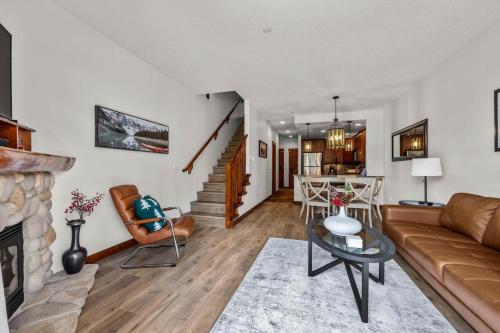 a living room with a couch and a fireplace at Trappers Landing #30 in Sun Peaks