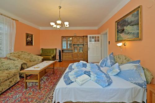 a living room with a couch and a table at Ambrózia Villa in Balatonfüred