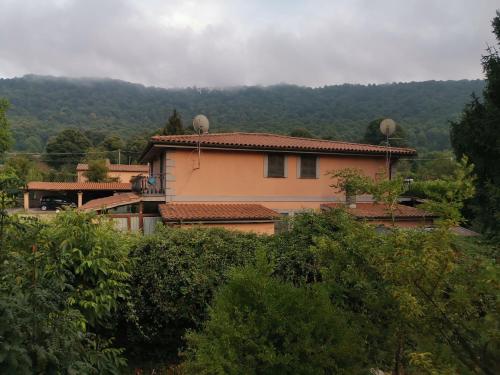 a house sitting on top of a hill with trees at La casa di Mario in Rocca di Papa