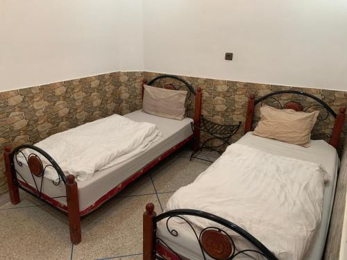 two beds sitting next to each other in a room at Paddle Out Morocco in Tamraght Ouzdar
