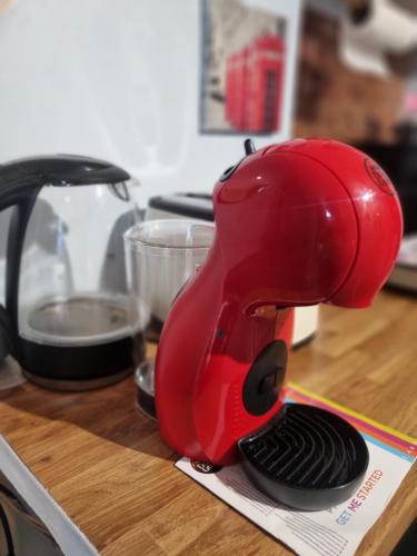 a red mixer sitting on top of a counter at Studio at 113b - a home away from home in Hampton Hill