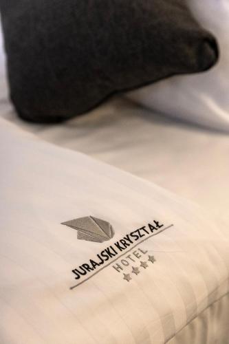 a close up of a bed with a paper airplane on it at Jurajski Kryształ in Zaborze