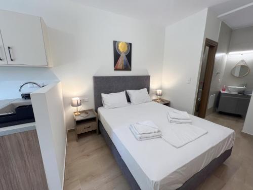 a bedroom with a white bed and a bathroom at AZOGIRE Resort in Azoyirés