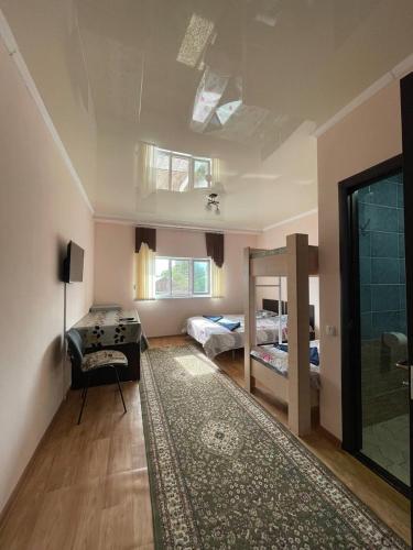 a room with a bedroom with a desk and a bed at Guest House Yukon in Bosteri