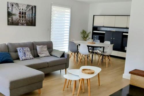 a living room with a couch and a table at Maison de vacances jusqu'à 6 personnes, classée 3 étoiles in Échillais