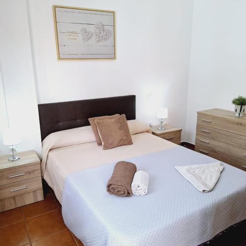 a bedroom with a bed with two towels on it at Apartamento Playa Rosa in Guía de Isora