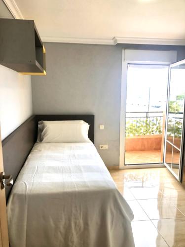 a bedroom with a bed and a large window at Marina Vista Puerto in Ceuta