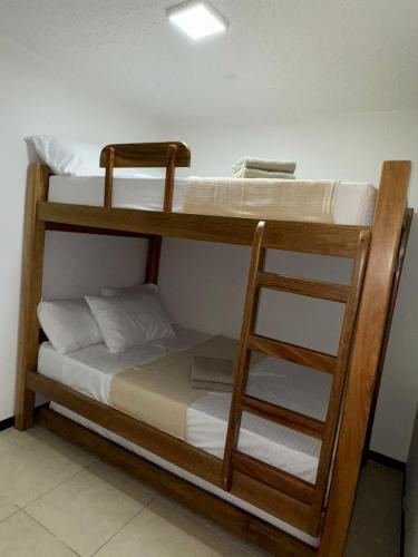 two bunk beds in a room with a ladder at Apartasol Ciudadela SantaFe de Antioquia in Santa Fe de Antioquia