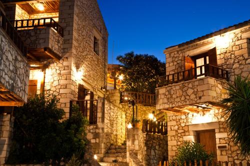 a stone building with lights on it at night at Tsivaras Villas in Tsivarás