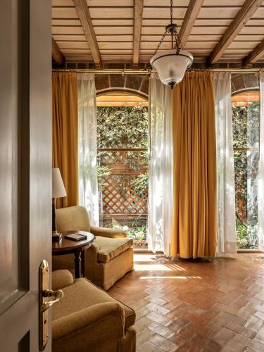 a living room with a couch and a table at Monasterio, A Belmond Hotel, Cusco in Cusco