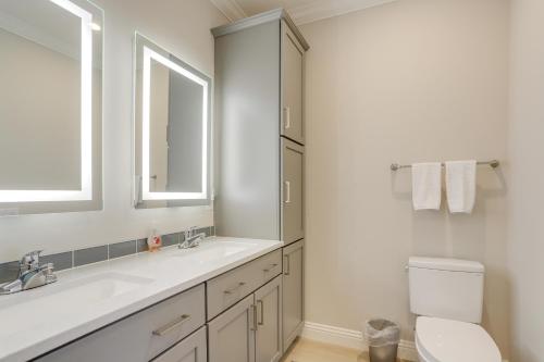 a bathroom with a sink and a toilet and a mirror at Lakeside Marblehead Home with Screened Patio! in Mineyahta-on-the Bay