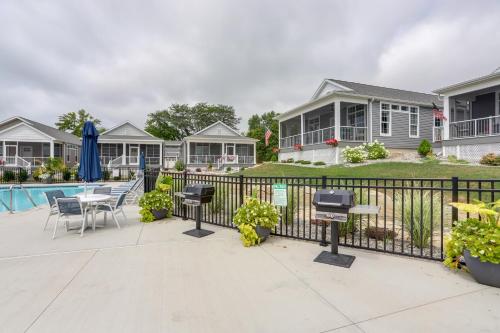 a patio with a fence and a table and chairs at Lakeside Marblehead Home with Screened Patio! in Mineyahta-on-the Bay