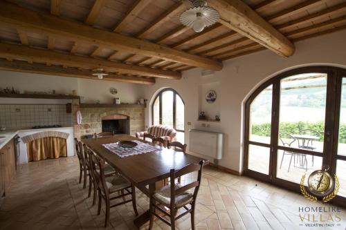 a kitchen and dining room with a table and chairs at Dreamy Brick Villa With Unbelievable View And A Pool in SantʼAngelo in Pontano