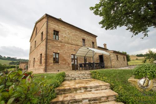 an old brick building with a table in front of it at Dreamy Brick Villa With Unbelievable View And A Pool in SantʼAngelo in Pontano