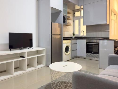 a living room with a couch and a table in a kitchen at 2 bdr cozy apt in Terra Branca, Free Wifi - LCGR in Praia