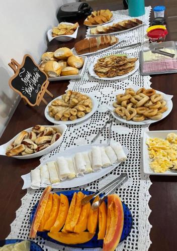 a table with many different types of food on it at Pousada Cunhantã in Alter do Chao