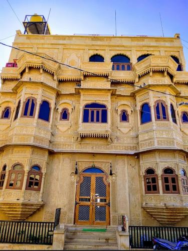 a large building with a large wooden door at Hotel Pol Haveli Jaisalmer in Jaisalmer