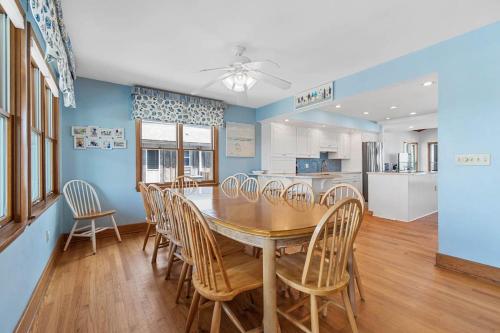 a kitchen and dining room with a table and chairs at Sunrise to Sunset Oceanfront Home with Creek Dock in Pawleys Island