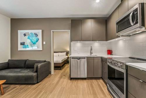 a kitchen and living room with a couch in a room at Nowhere Special Hostel in Rossland