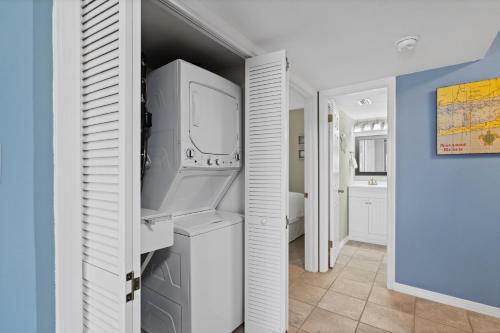 a kitchen with a refrigerator and a washer and dryer at Sundunes Unit 133 in Navarre