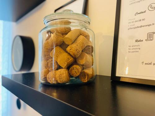 a glass jar filled with rocks on a shelf at La Chambre St Vincent in Épernay