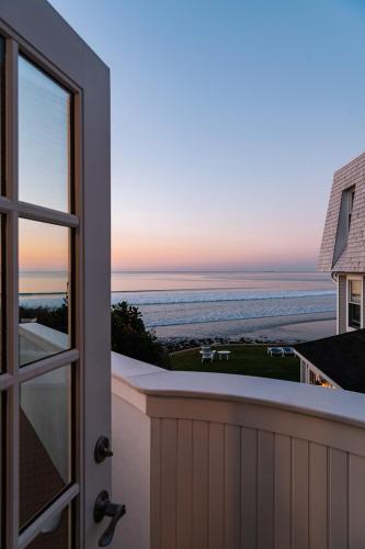 a door to a balcony with a view of the ocean at Cutty Sark Motel in York Beach