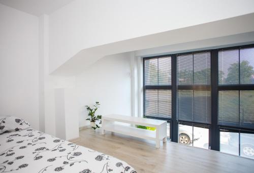 a bedroom with a bed and a large window at Apartament Bierutowska in Wrocław