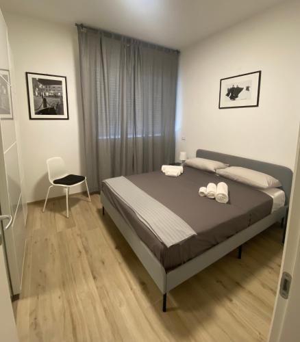 a bedroom with a bed and a chair in it at Casettadellafotografia in Senigallia