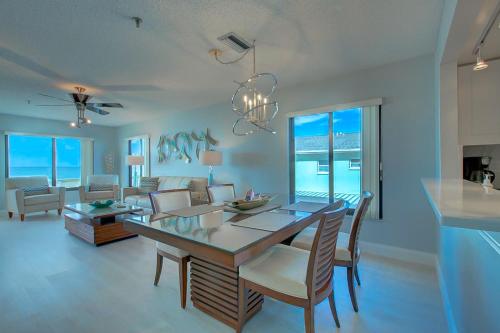a dining room and living room with a table and chairs at Anna Maria Island Beach Sands in Bradenton Beach