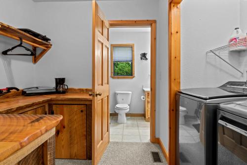 a kitchen with a toilet and a door to a bathroom at The Cabin Kingdom Hot tub Fire Pit in Blairsville