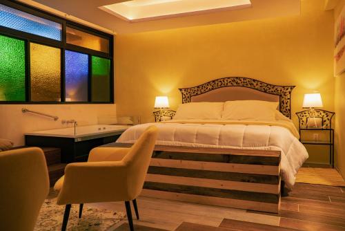 a bedroom with a large bed and a bath tub at Hotel Tepeyac in San Cristóbal de Las Casas