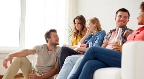 a group of people sitting on a couch at Governors Village - 1,2,3 & 4 Bedroom Apartments on Seven Mile Beach Corridor in George Town