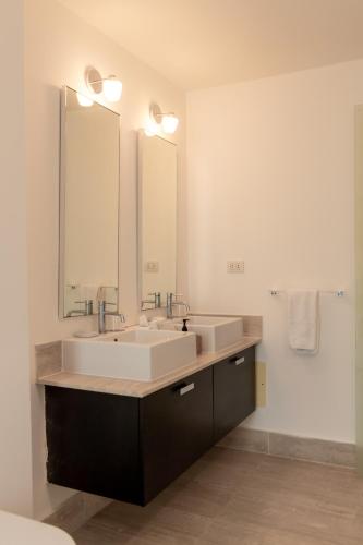 a bathroom with two sinks and a large mirror at The Ocean Club, a Luxury Collection Resort, Costa Norte in Sosúa
