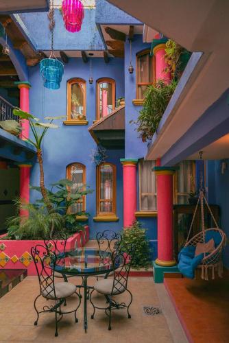 a room with a table and chairs in front of a building at Hotel Tepeyac in San Cristóbal de Las Casas