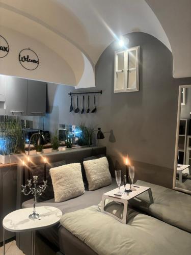 a living room with a couch and two tables at Studio Old Town in Maribor