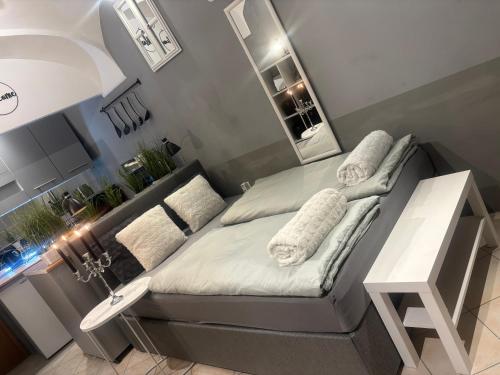 a small bedroom with a bed and a mirror at Studio Old Town in Maribor